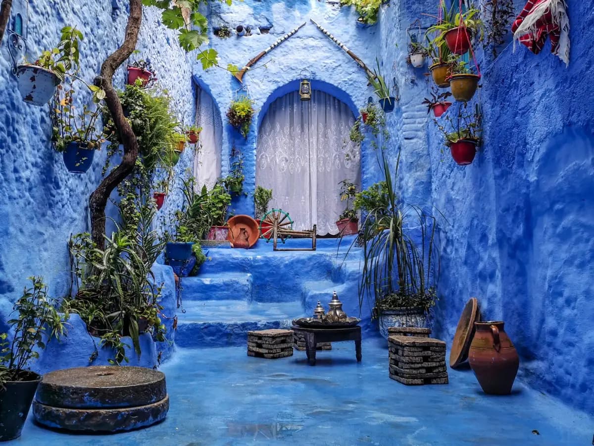Blue-painted courtyard with plants and traditional details in Chefchaouen, Morocco