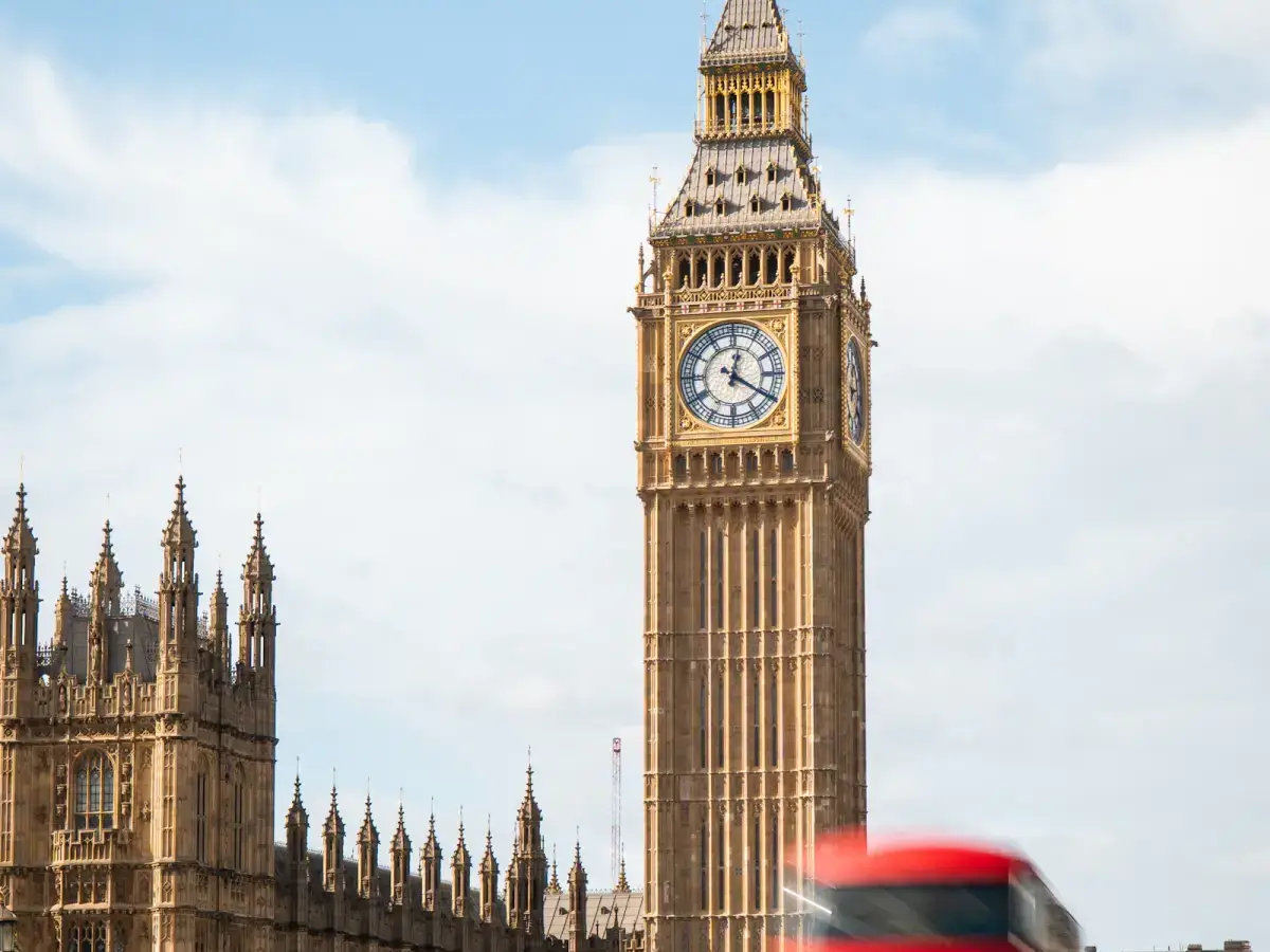 Big Ben and red double-decker buses moving through London, United Kingdom